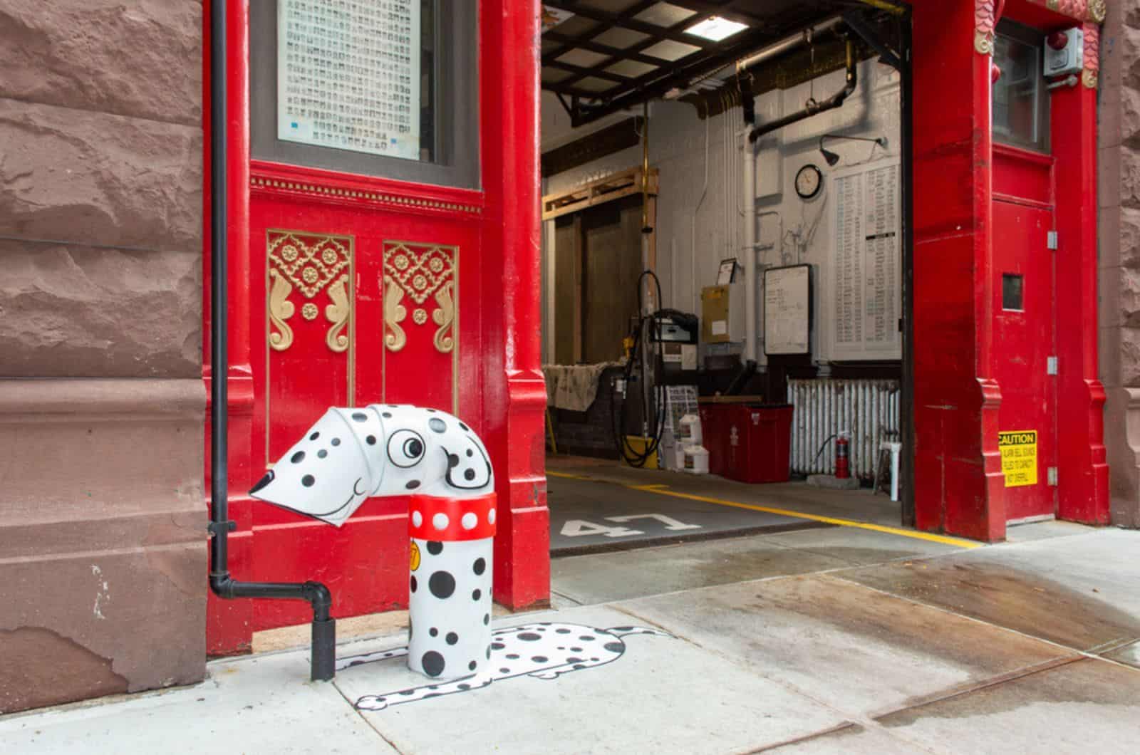 fire hydrant painted like spotted dalmatian at fire station