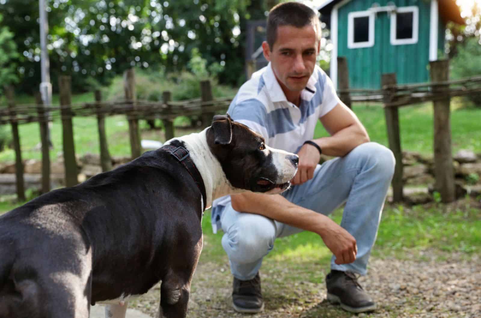 man and his pitbull outdoors