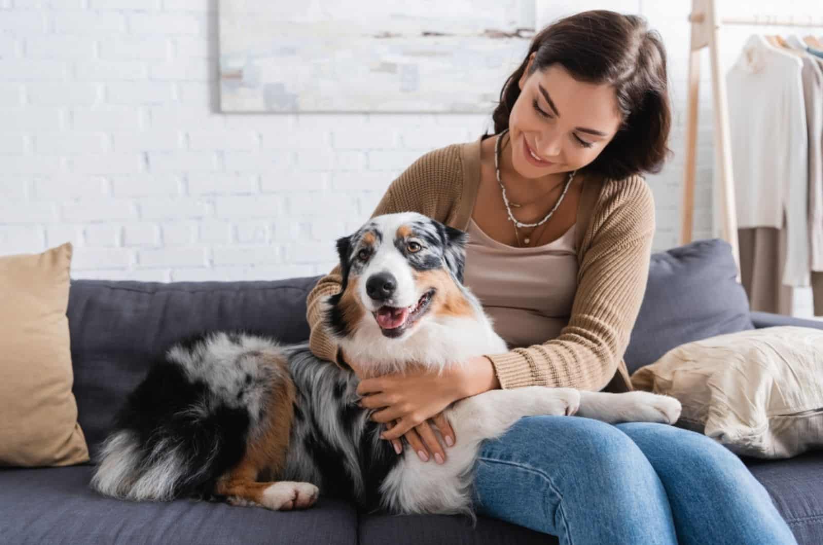 woman hugging her dog in the living room