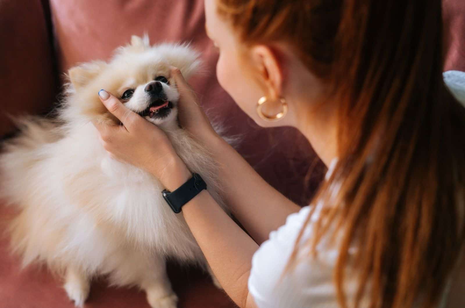 woman playing with her dog at  home