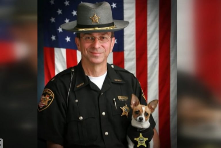 policeman with dog posing