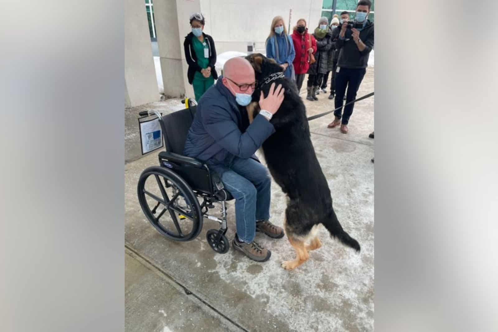 a man hugs a rescue dog