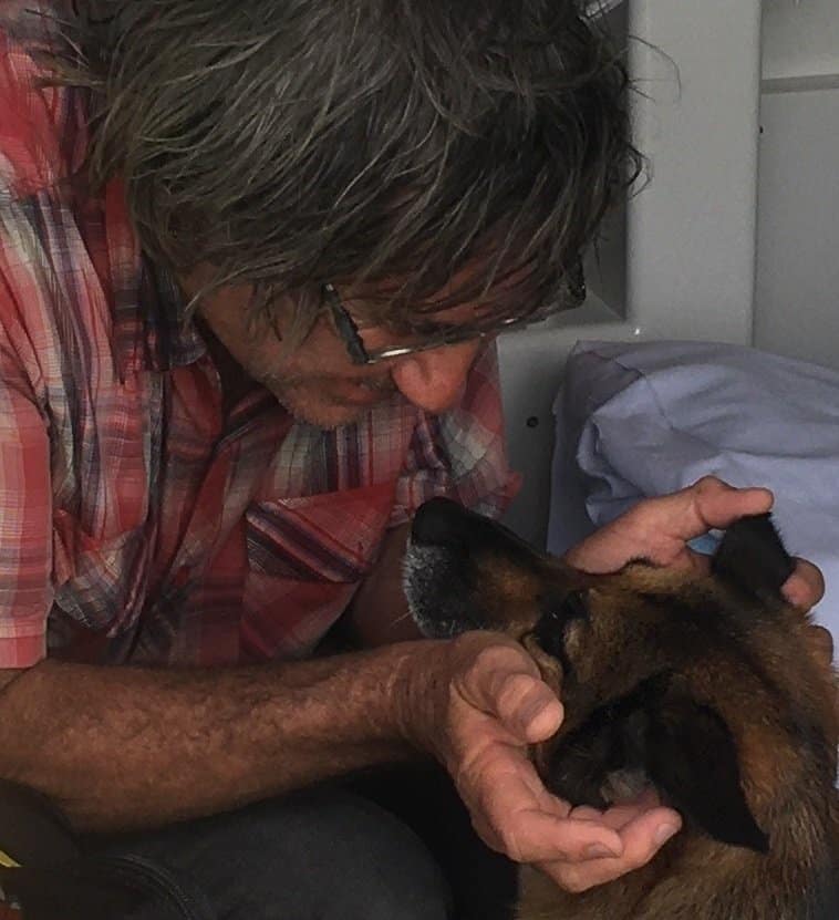 a man petting a police dog