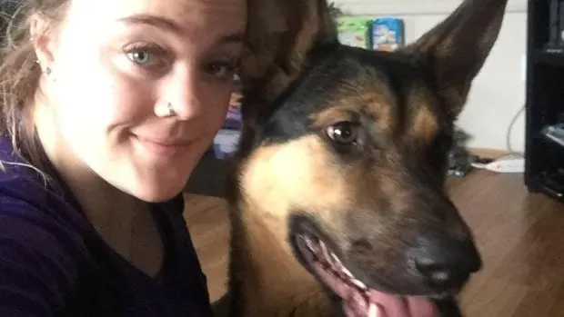 a woman takes a picture with a dog