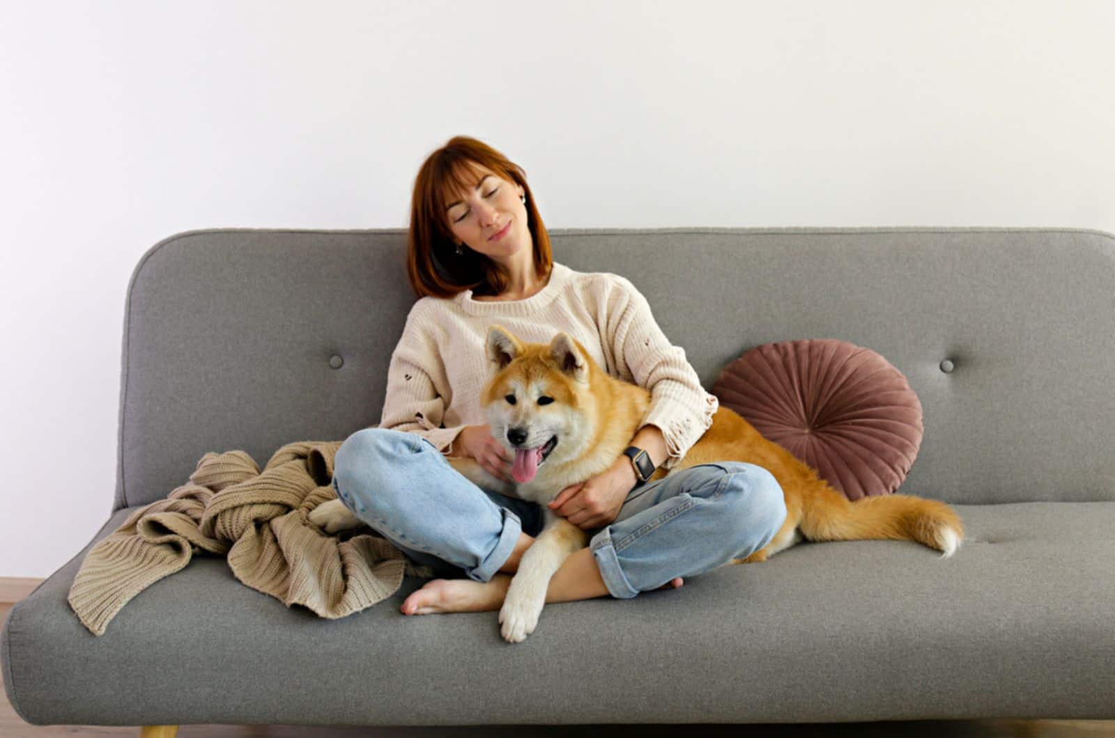 dog sitting with his owner on the couch