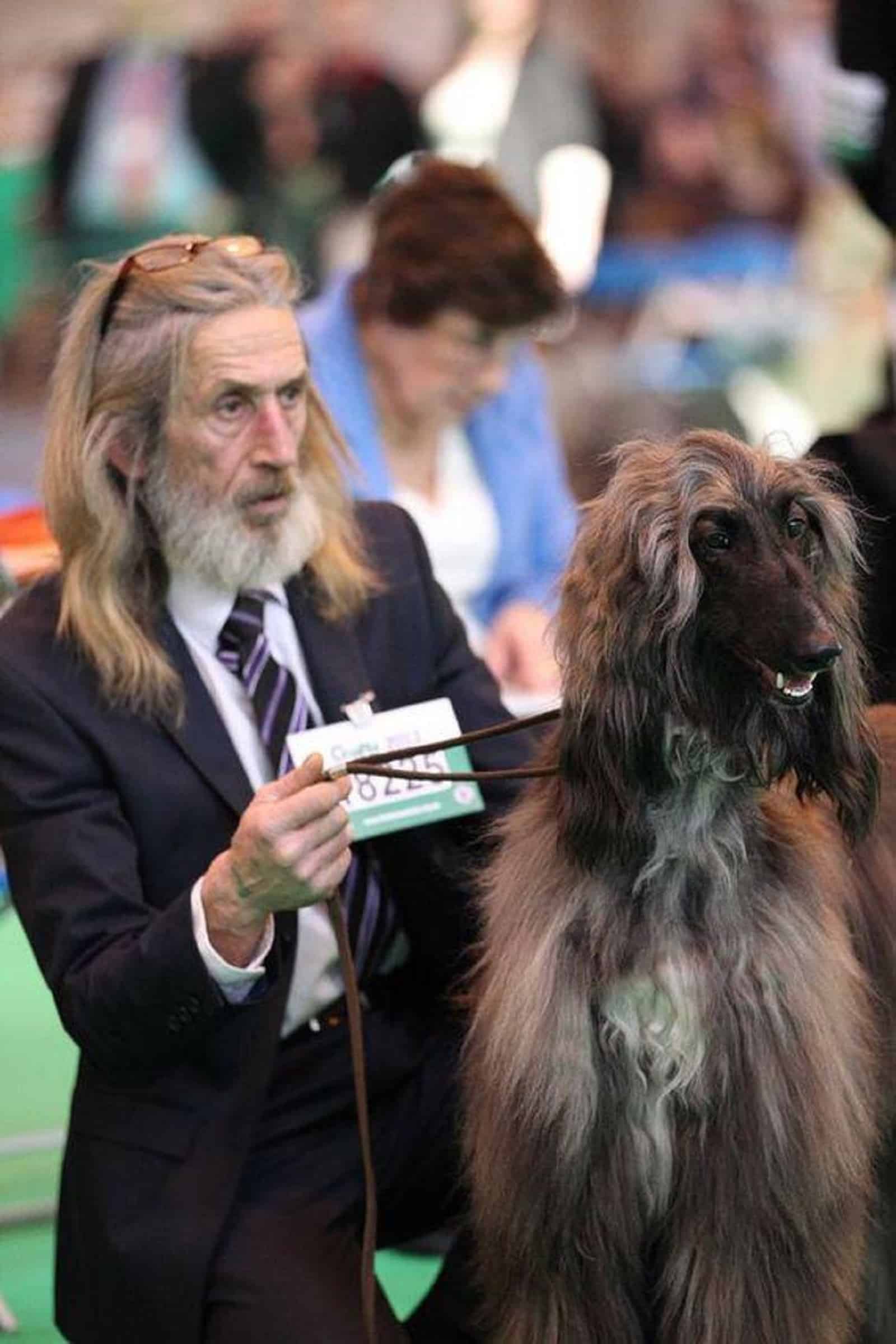 man with long hair and his dog with long hair
