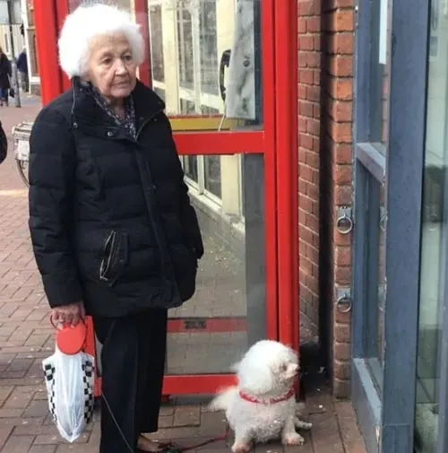older lady and dog standing outside