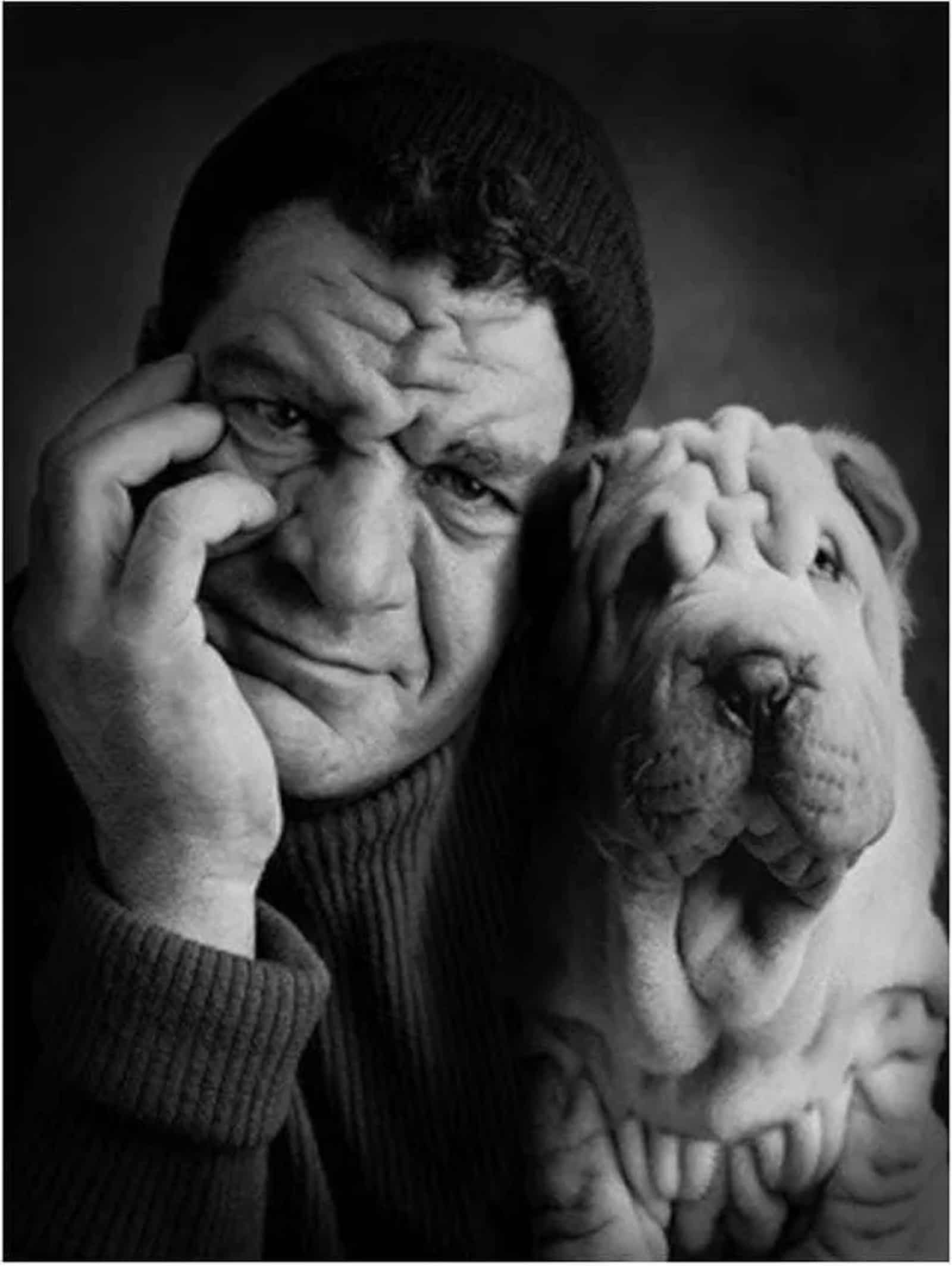 owner and his dog with wrinkles posing 