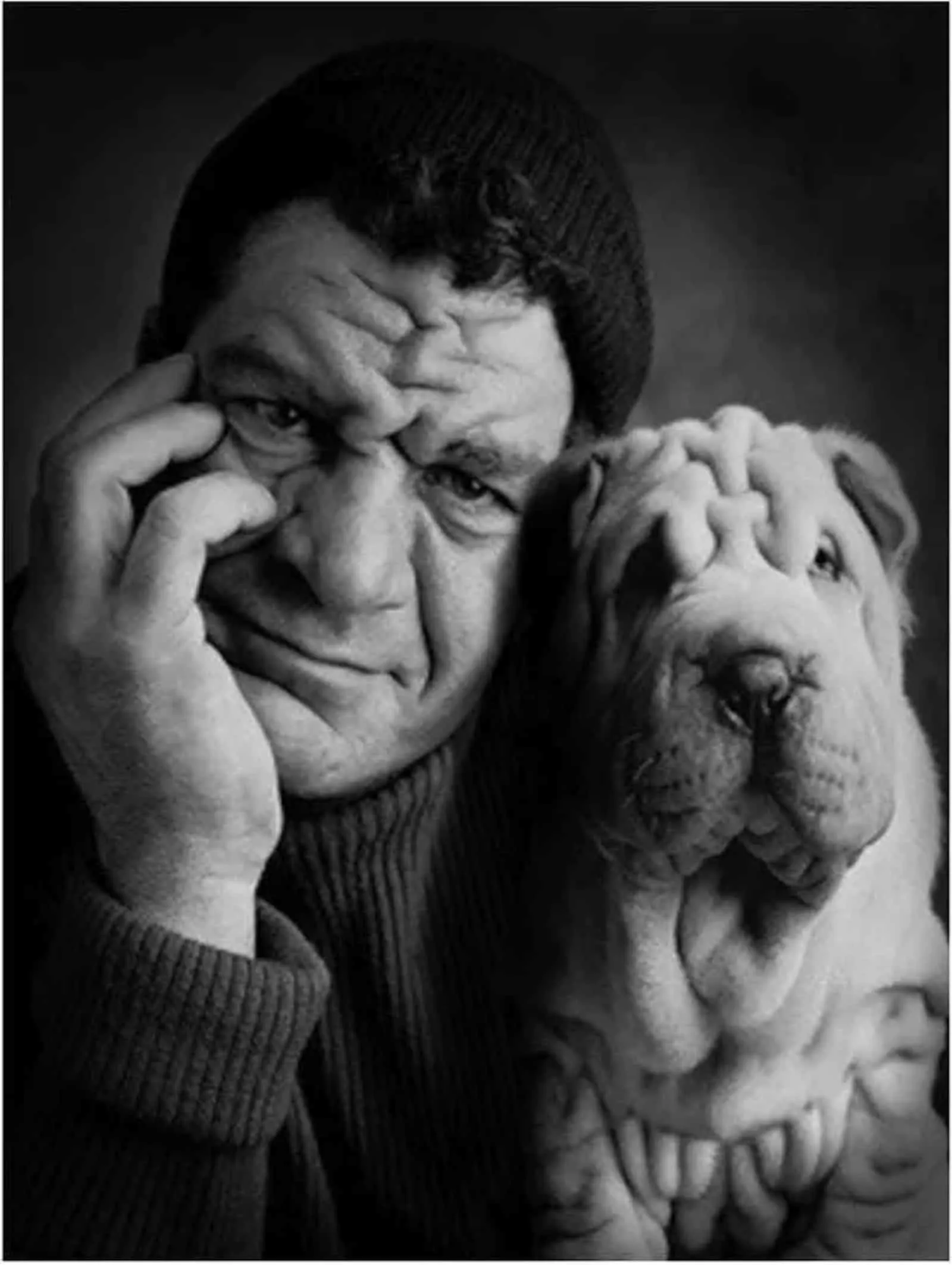 owner and his dog with wrinkles posing