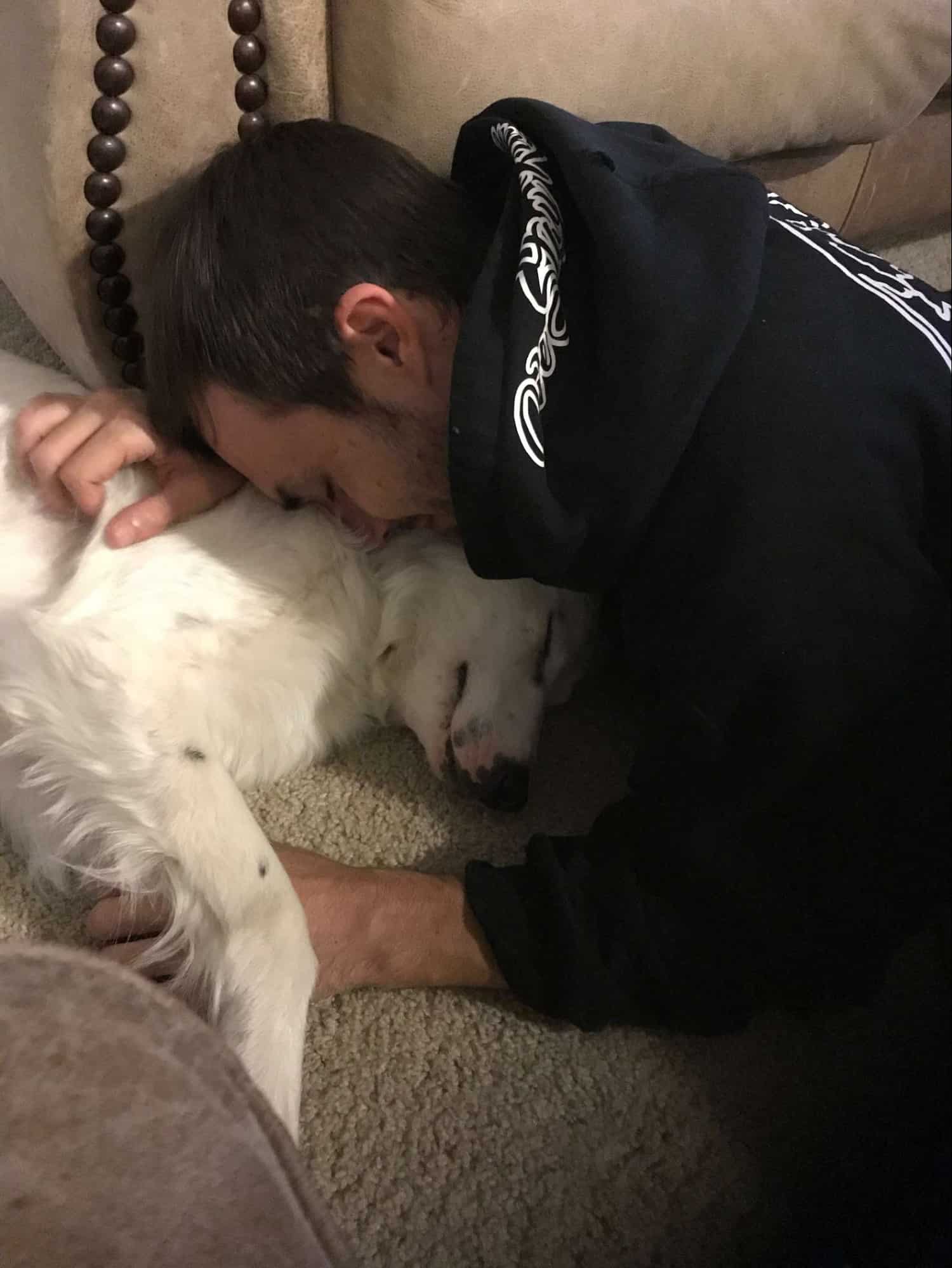 owner cuddling a rescued dog