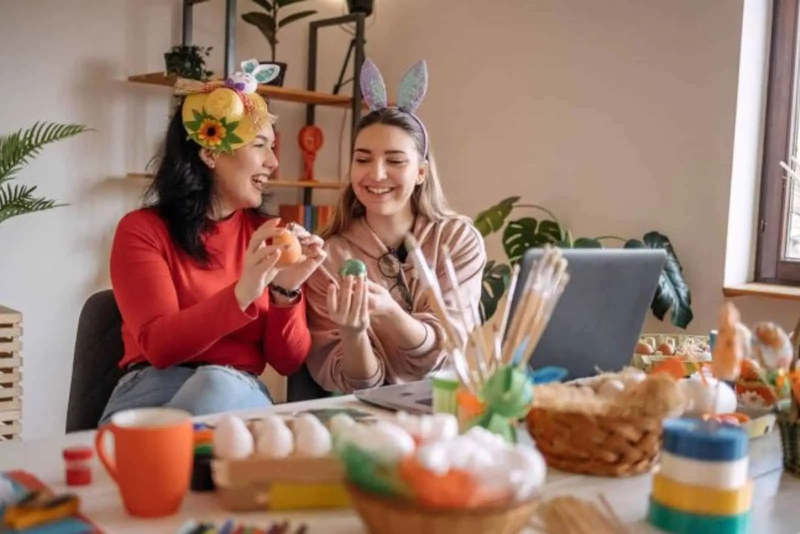 two women decorating easter eggs at home