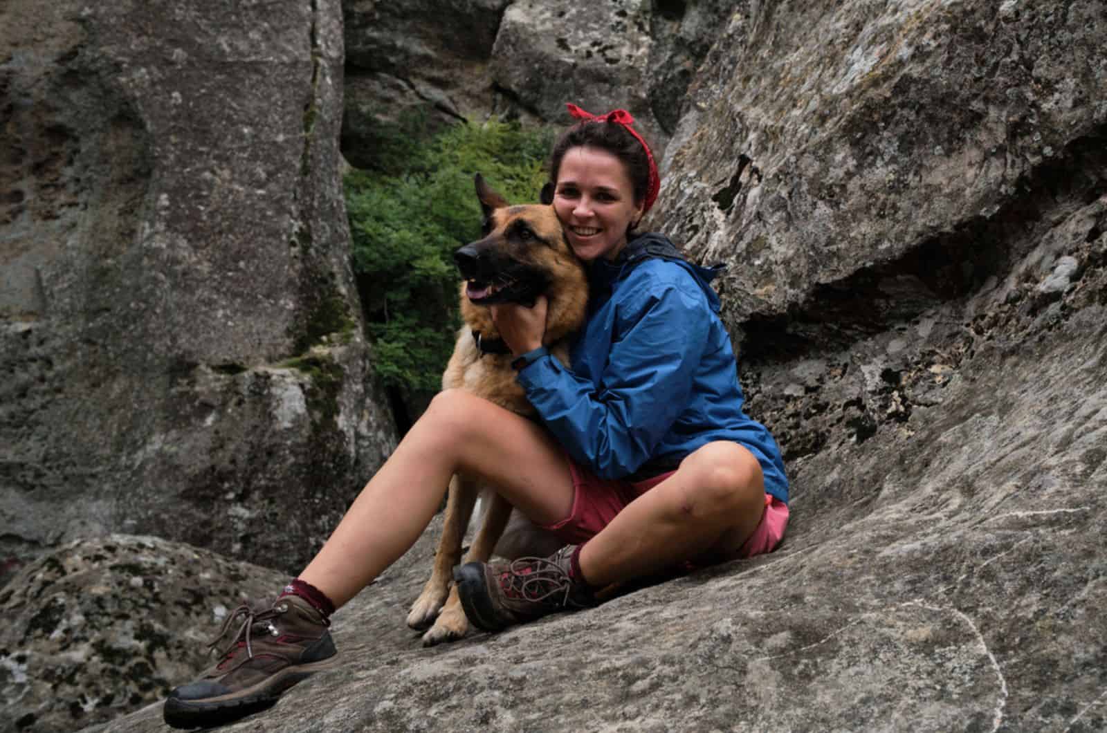 woman hiking with her german shepherd in mountains