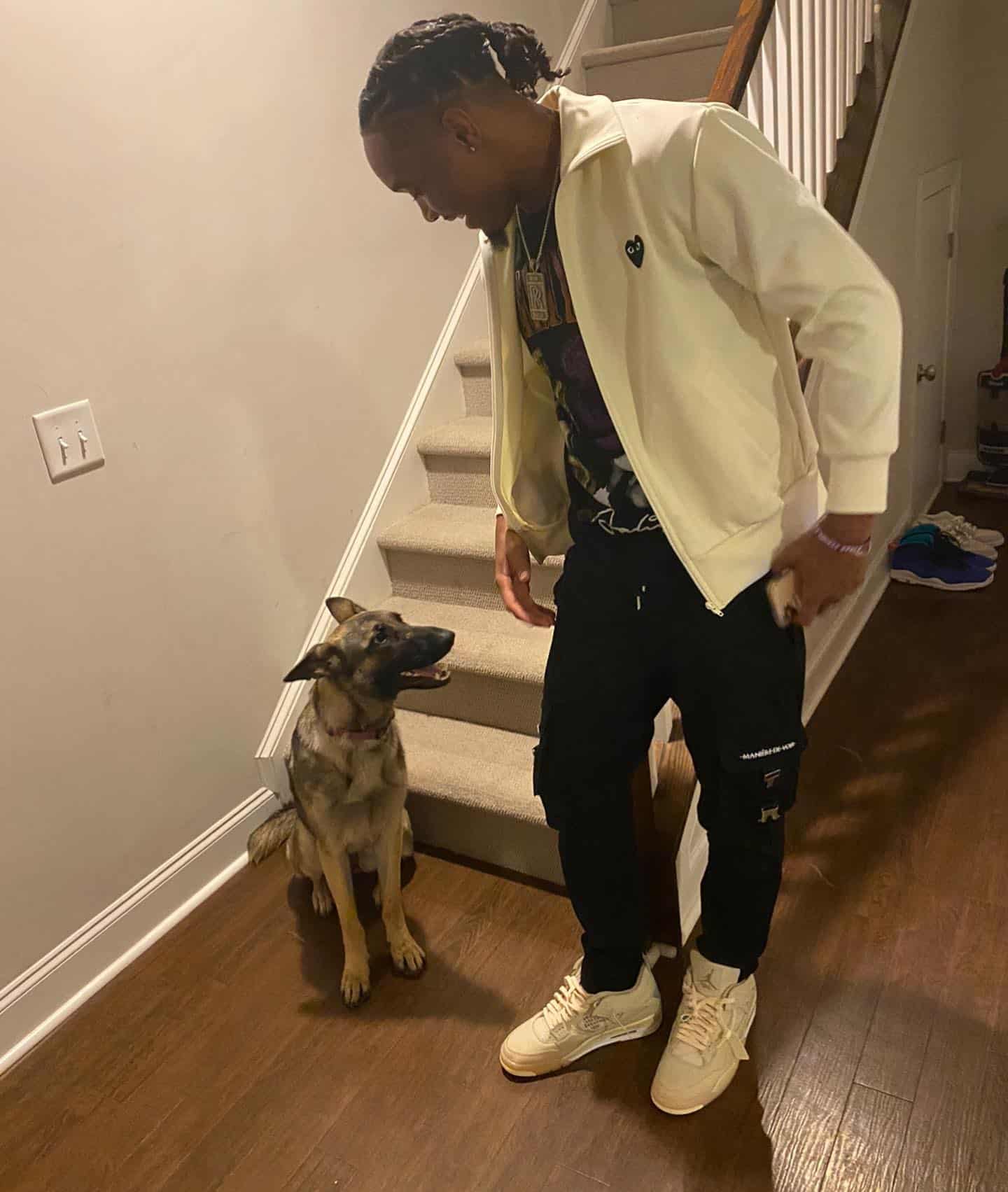 young man at home with dog