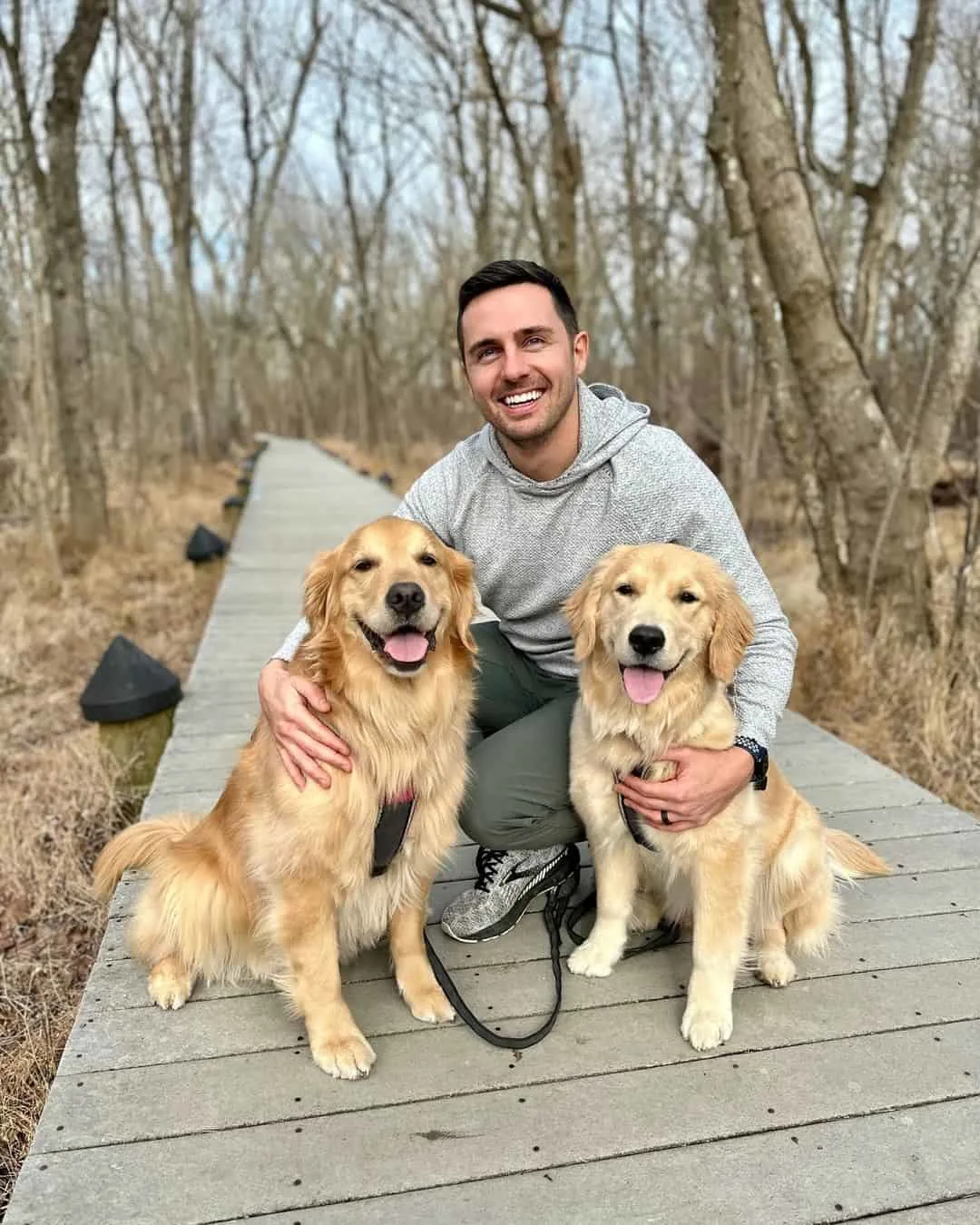 Photo of a man spending time with his dogs