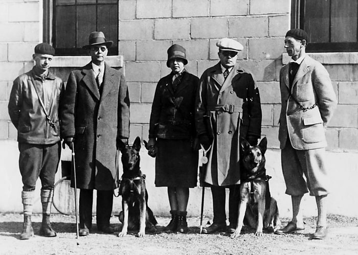 The first graduates from The Seeing Eye, Tartar and Gala, with their owners and trainers