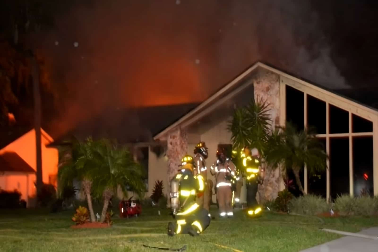 firemen with burning house