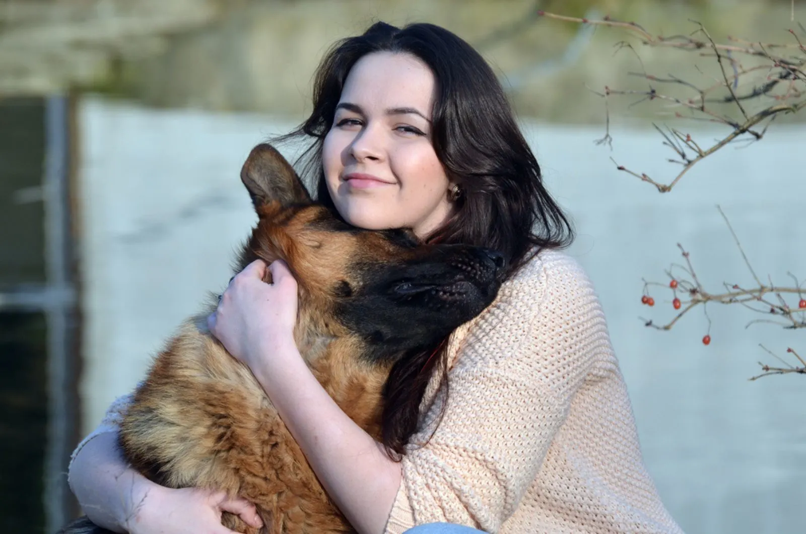girl hugging her german shepherd dog outdoors