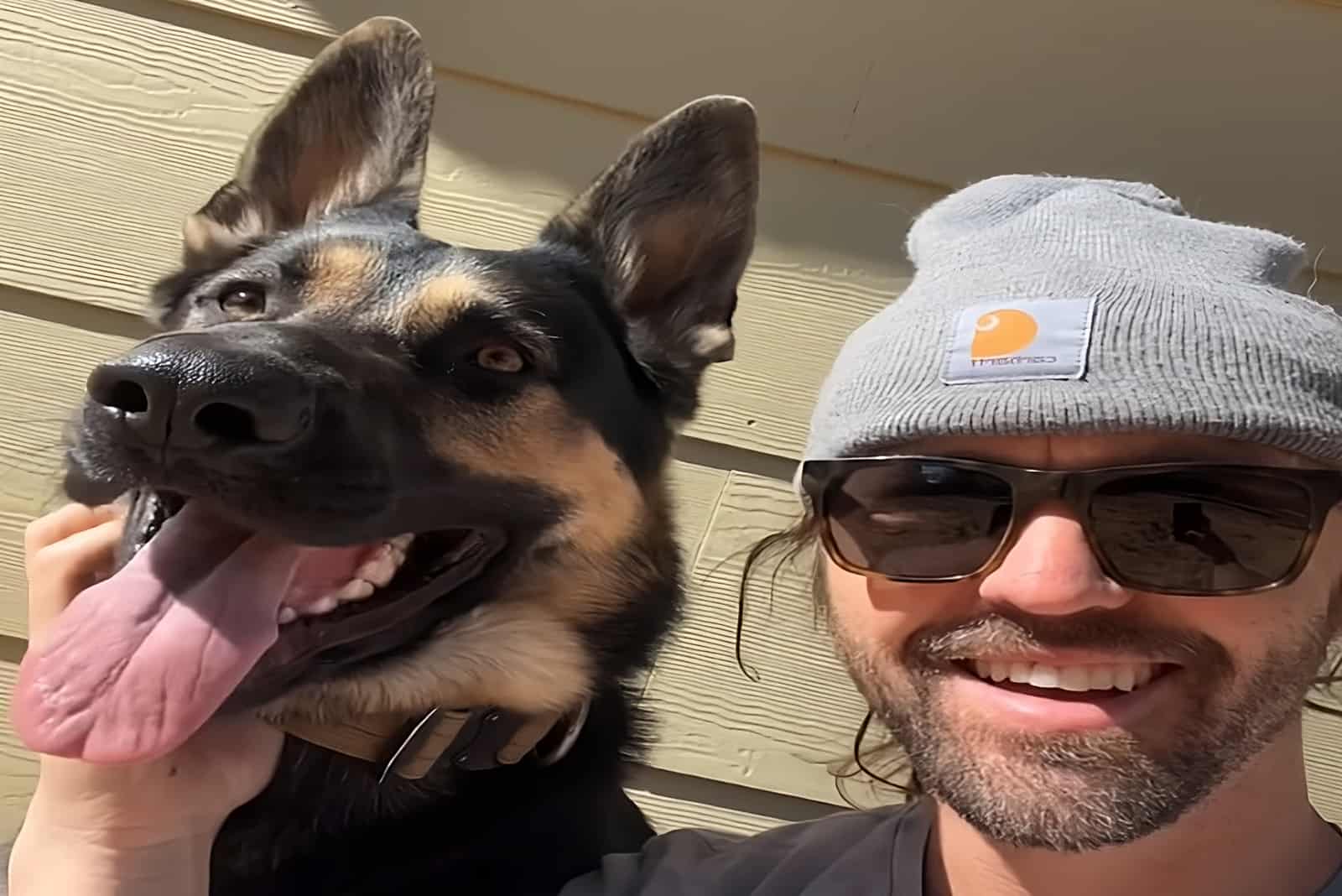 man with sunglasses taking selfie with his dog