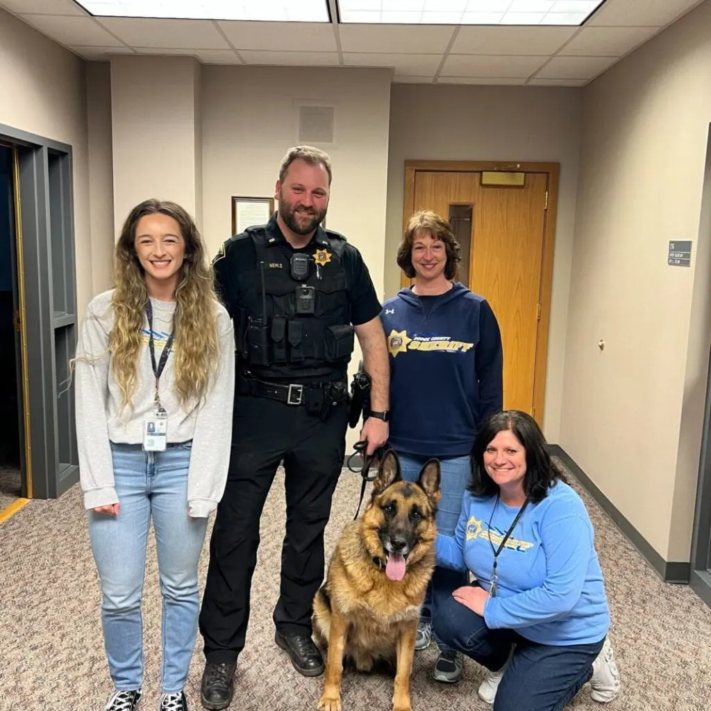 retirement german shepherd with police officer and women