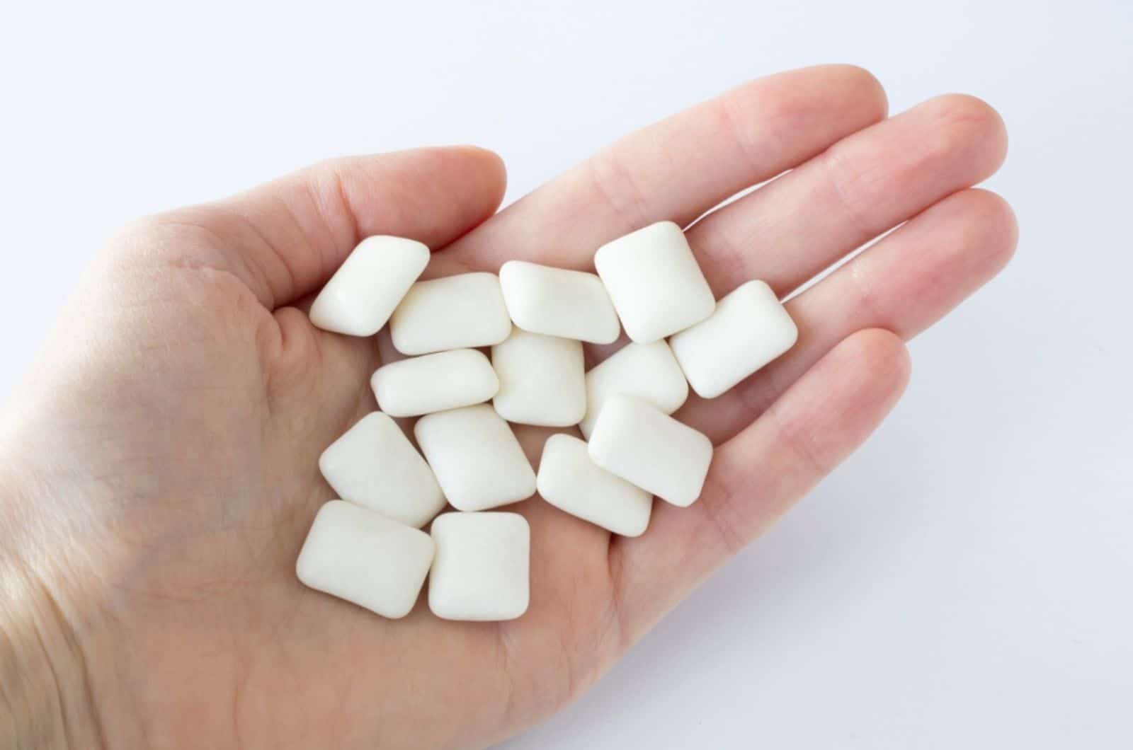 sugar-free xylitol gum for teeth in a woman's hand