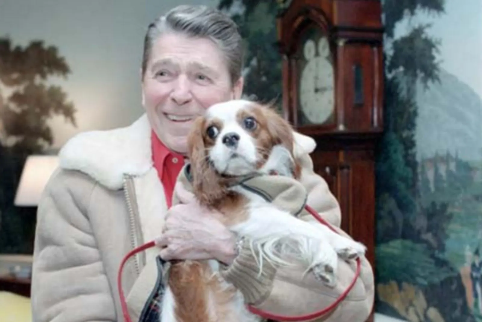 Rex Reagan holds a dog in his arms