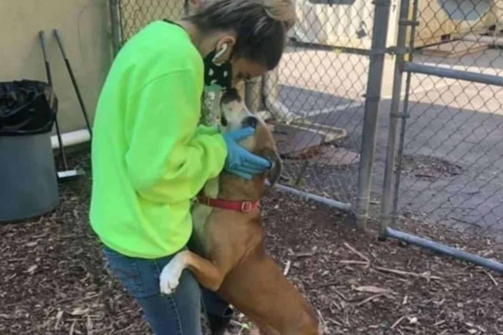 a woman cuddles with a rescued dog