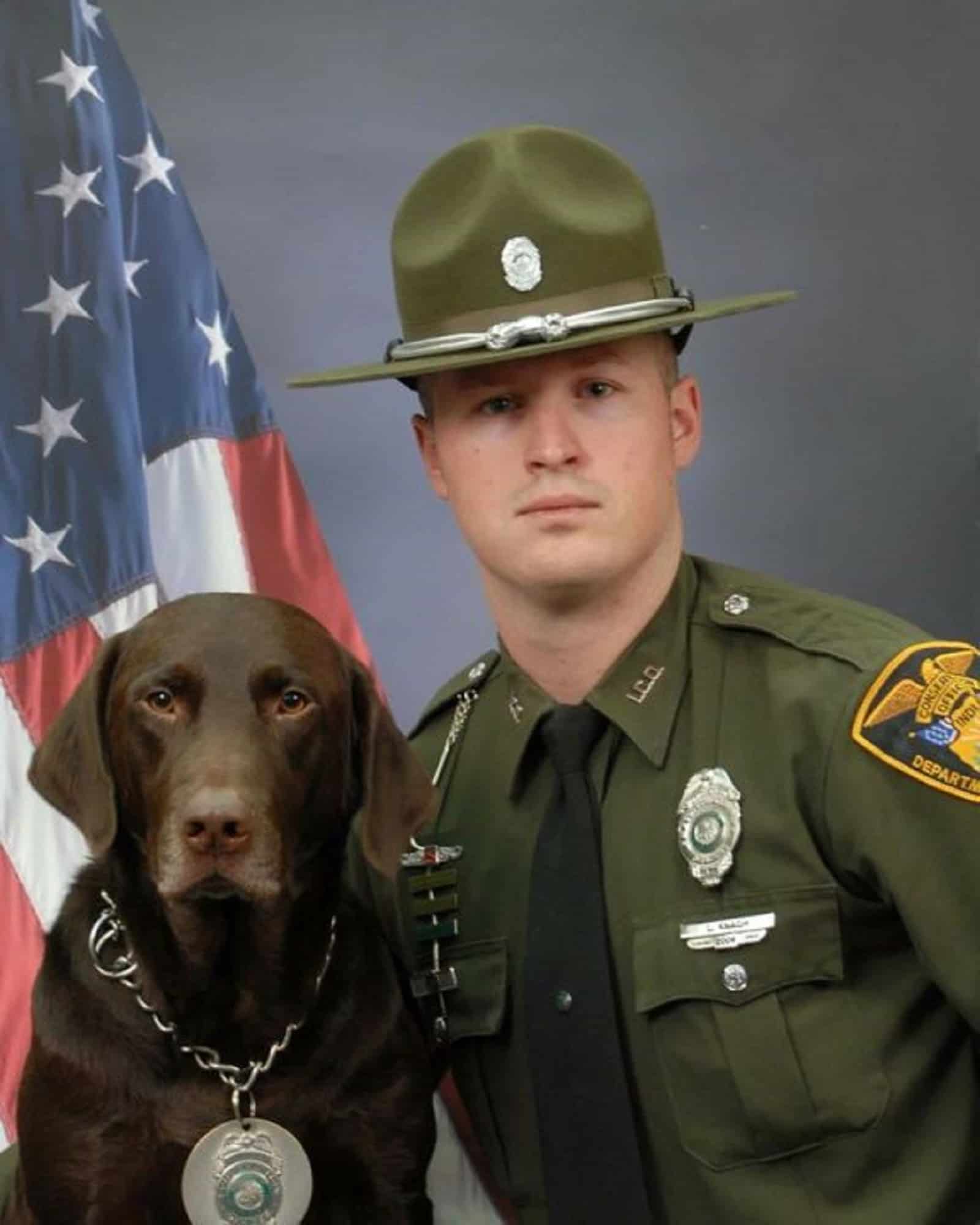 dog and police officer posing