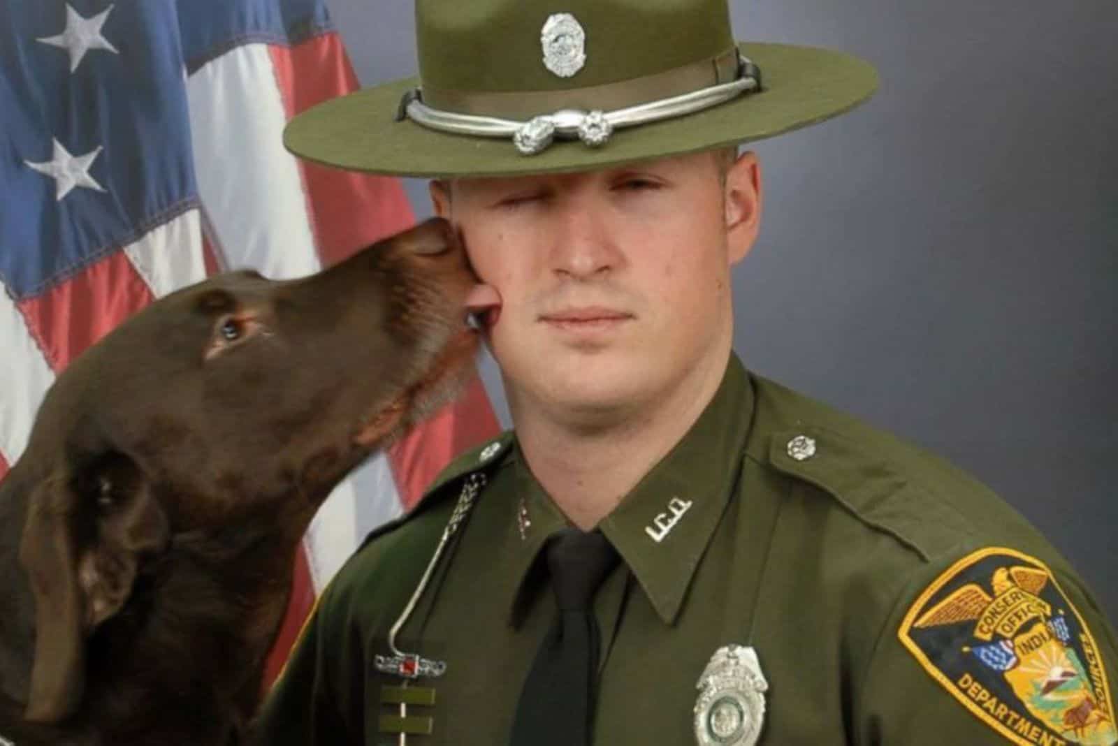 dog licking conservation officer during photoshoot