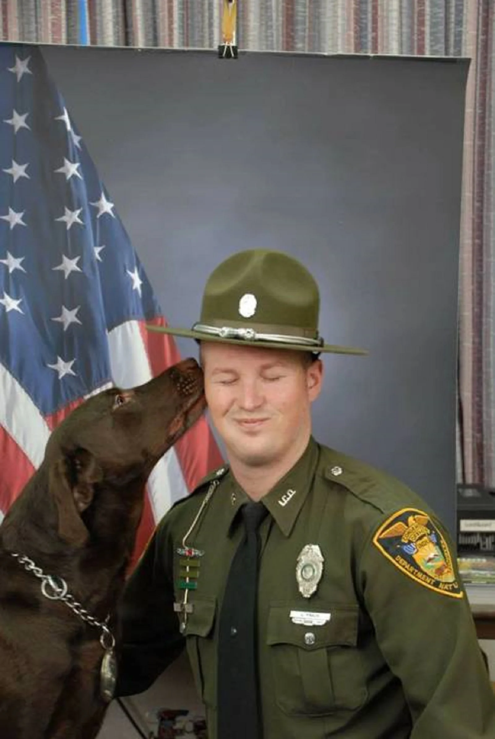 dog licking police officer during photoshoot