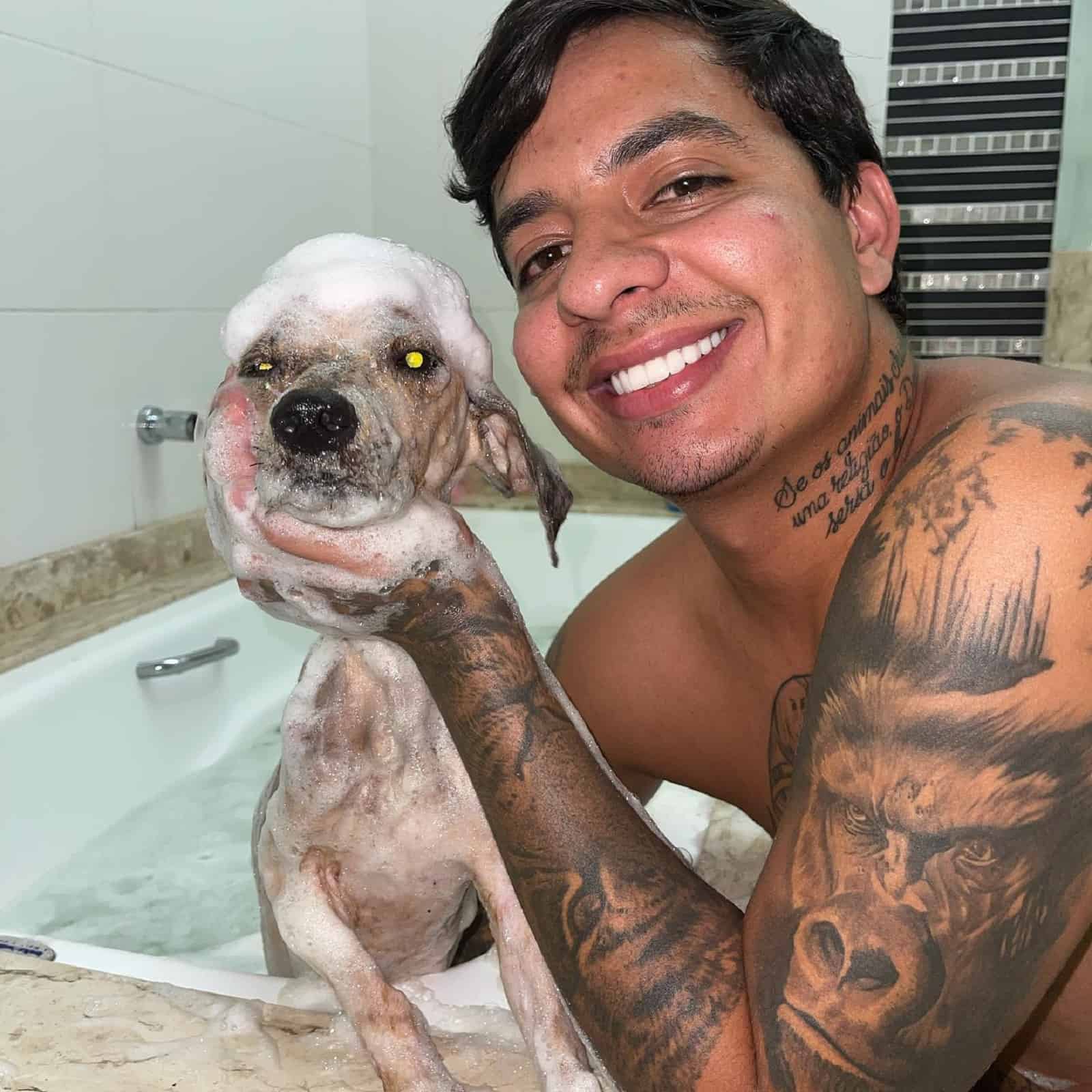 man bathing a puppy for a first time