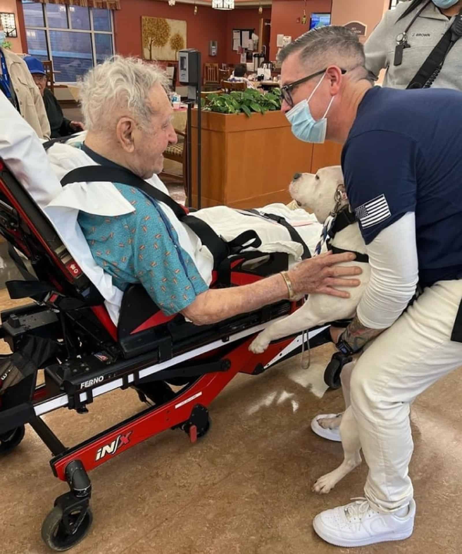 old man cuddling cole the deaf dog from hospital bed