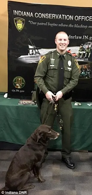 police officer with dog posing for image