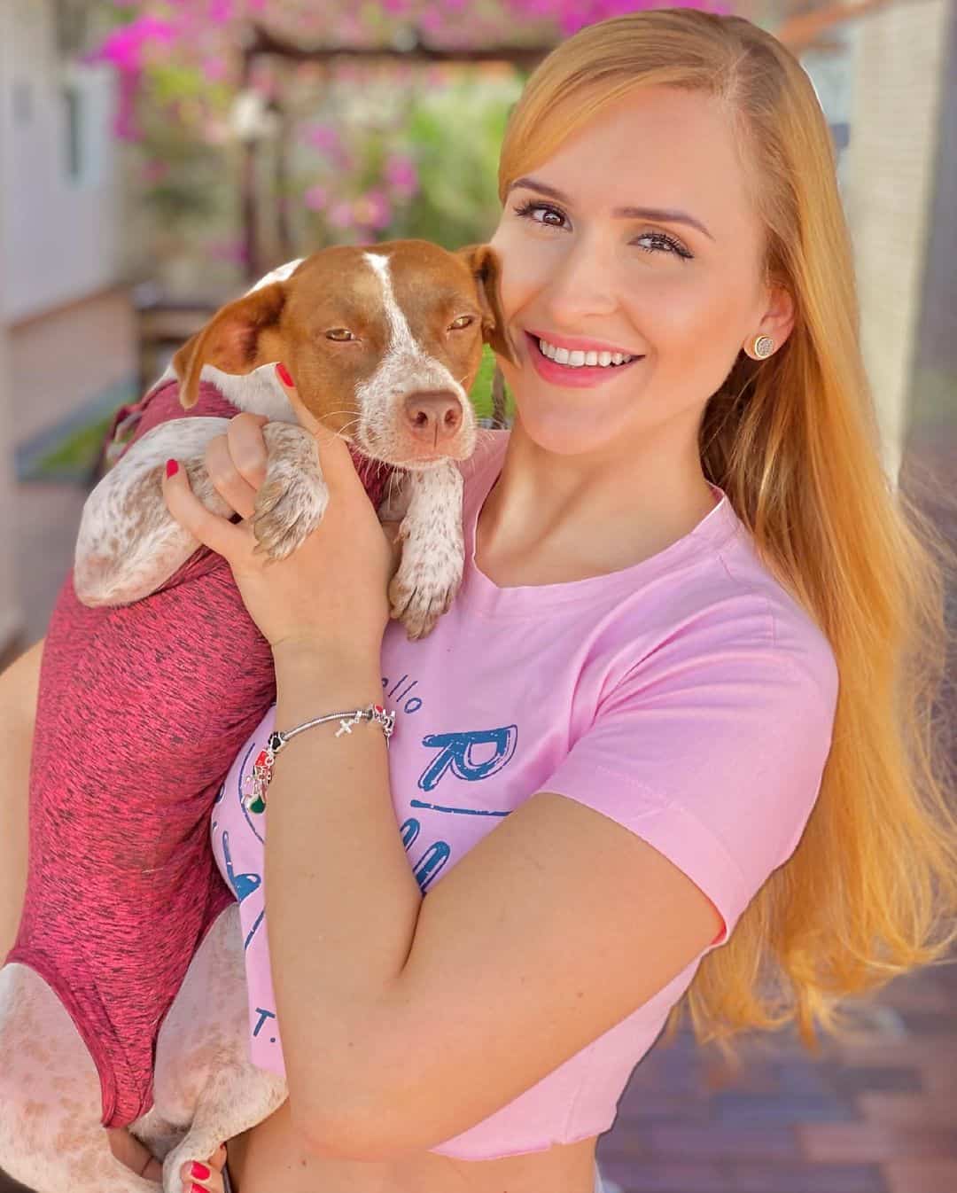 woman holding her dog in arms