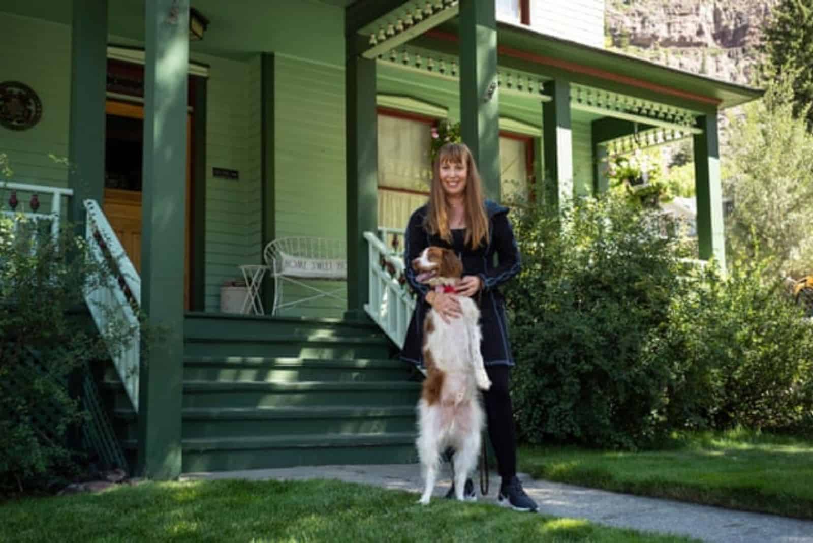 woman hugging her dog standing on two legs