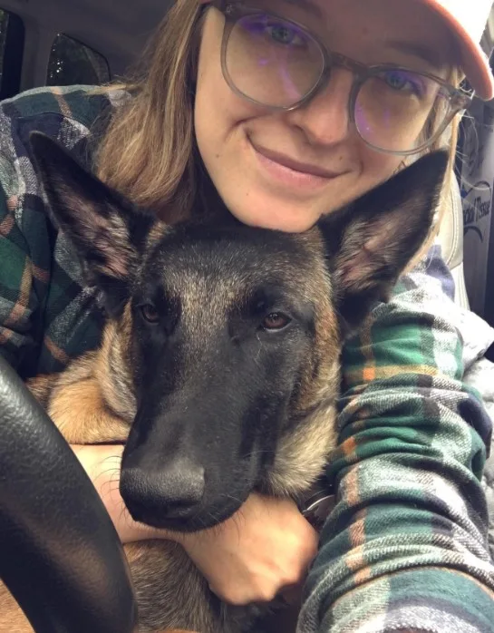 Belgian Malinois takes a picture with a girl in the car