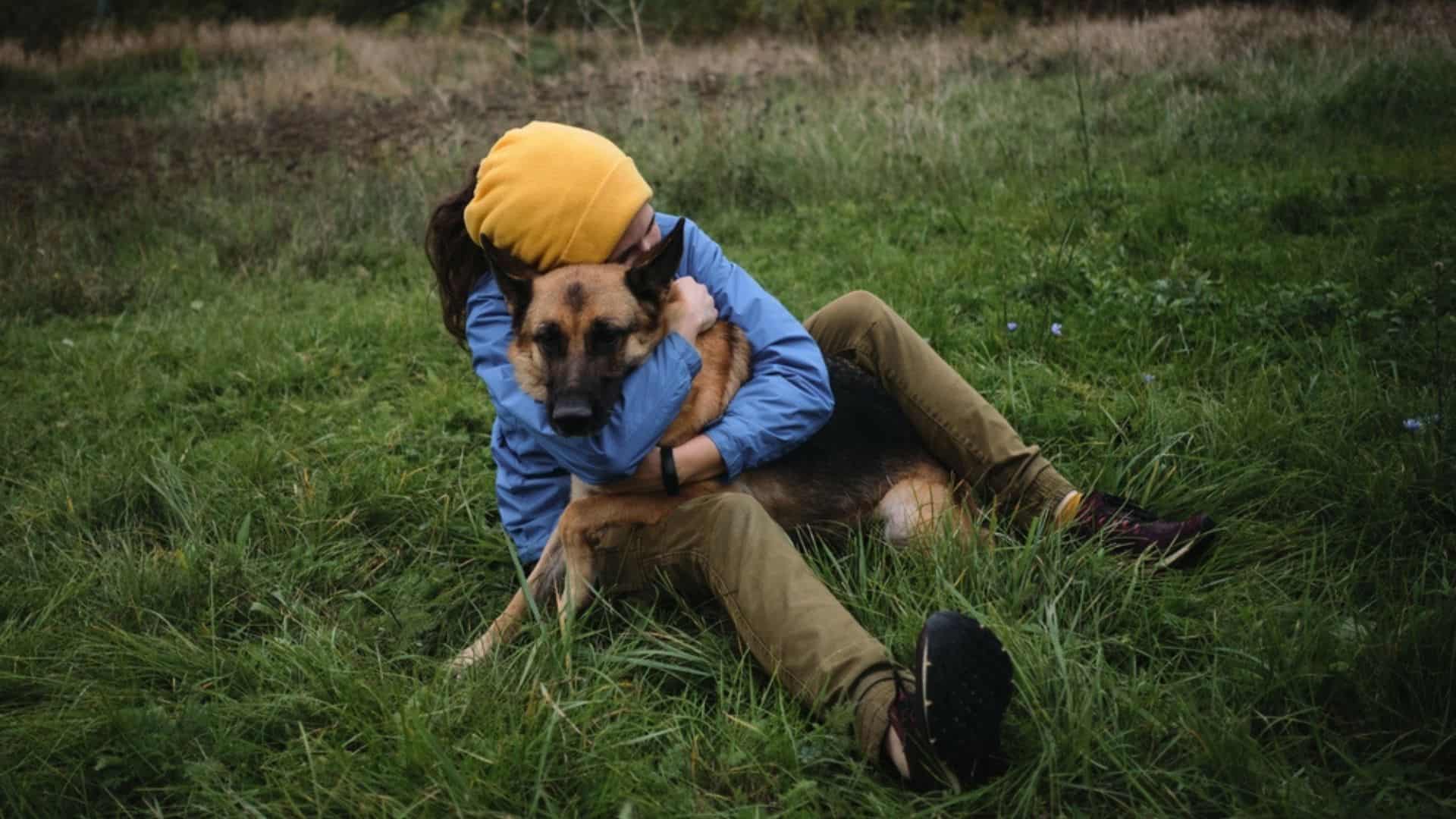woman hugging her german shepherd dog