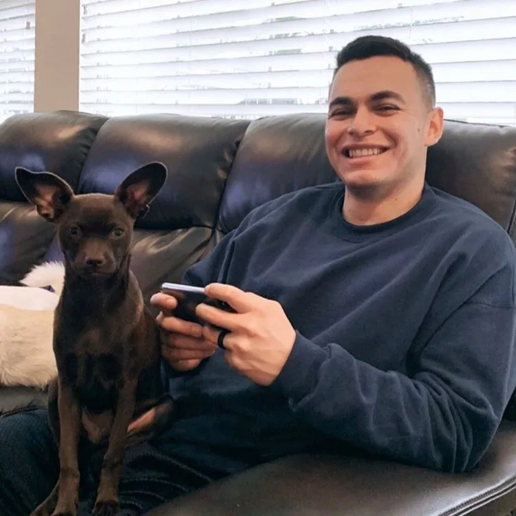 happy man with dog on the couch