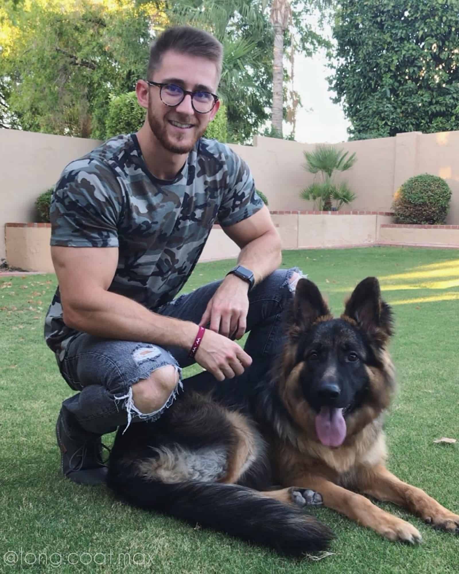 man and his german shepherd dog in the garden
