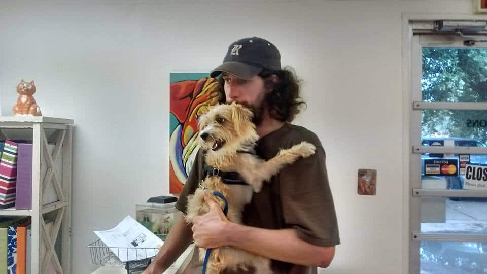 man holding a dog in arms