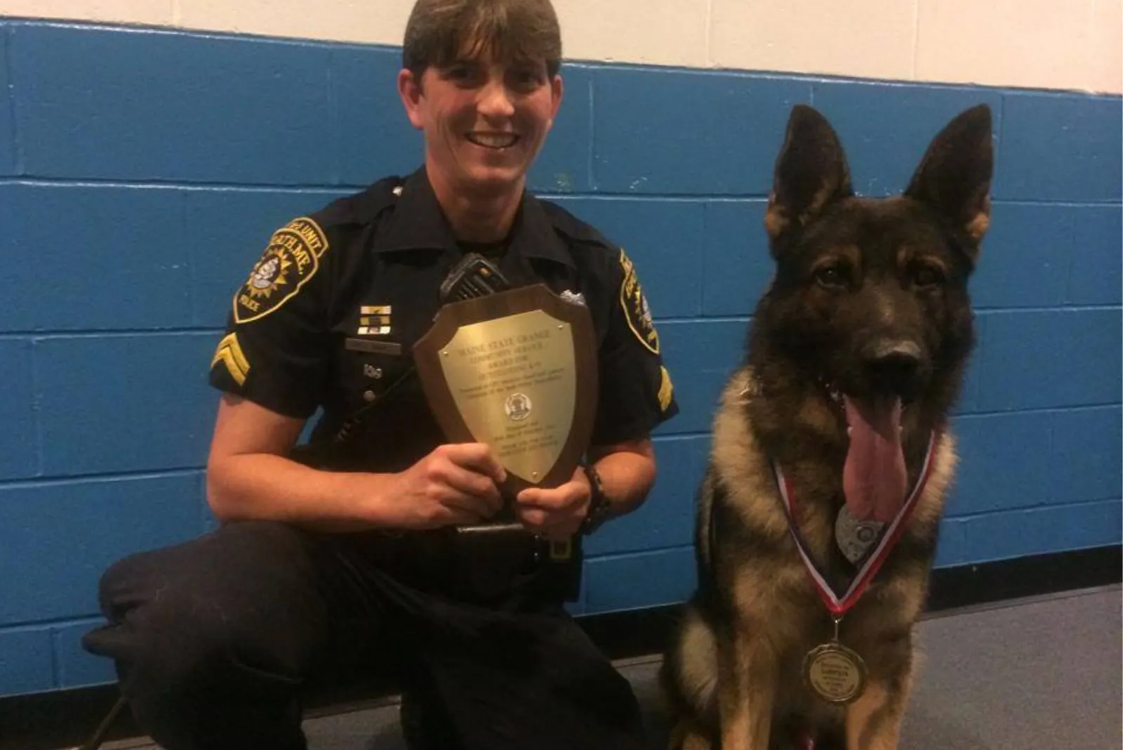 police officer and german shepherd dog with their medals