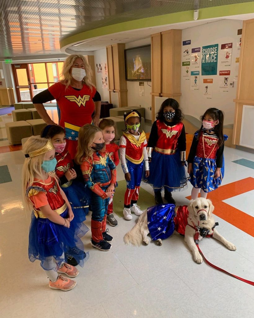 ruby wearing a Halloween costume next to kids