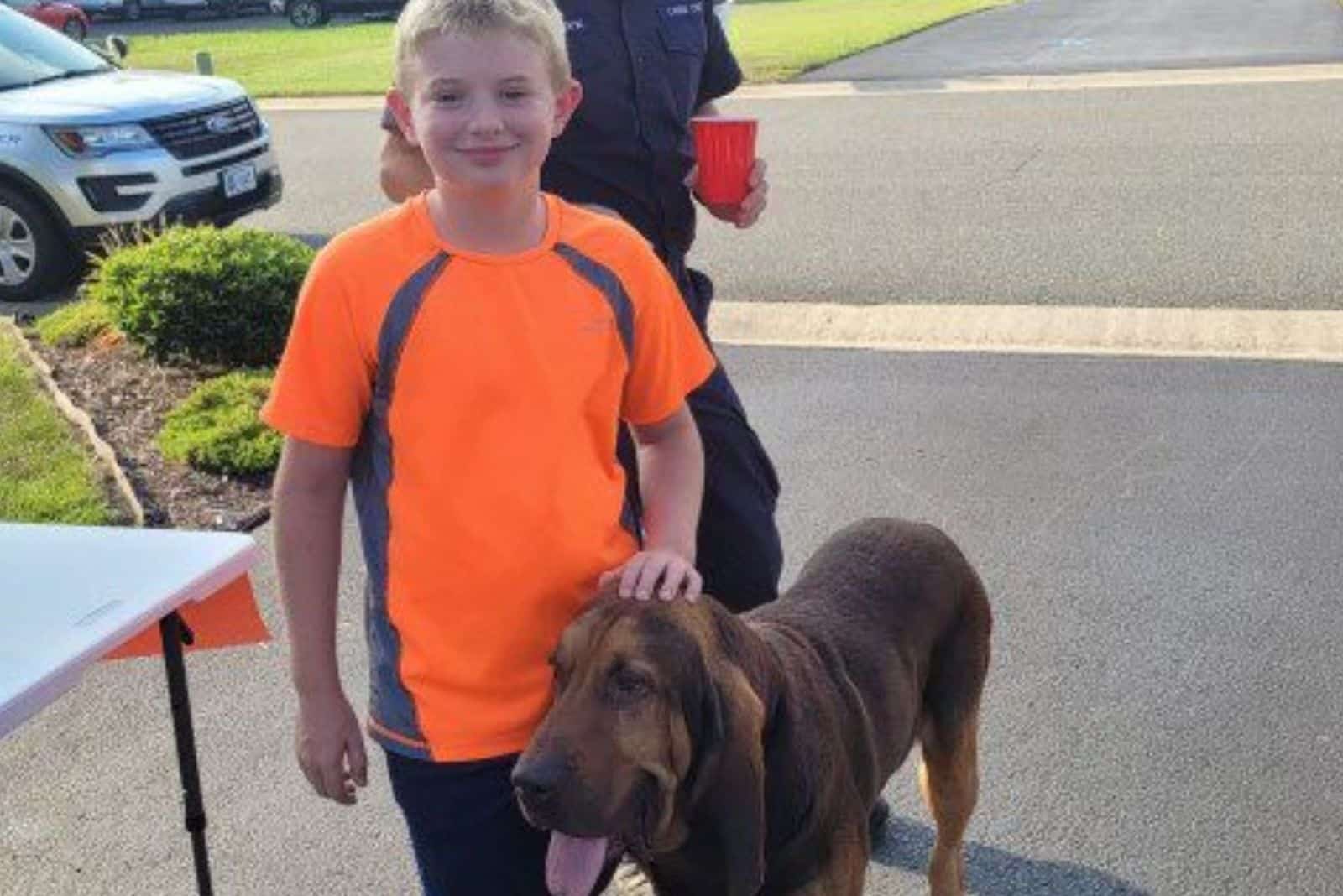 the boy is petting the dog