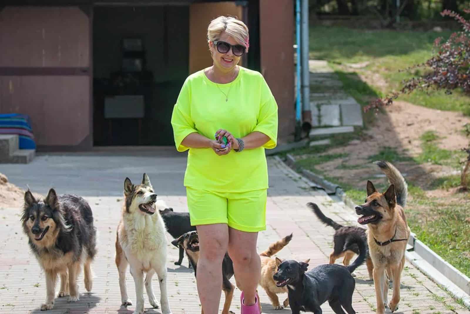 woman with dogs standing outdoors