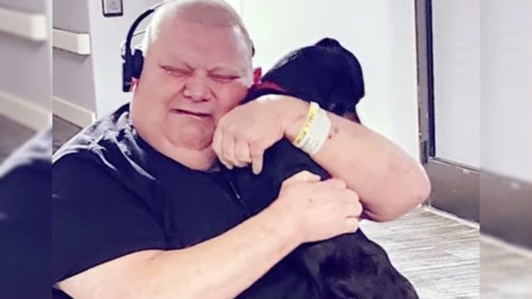 a man cries and hugs a dog