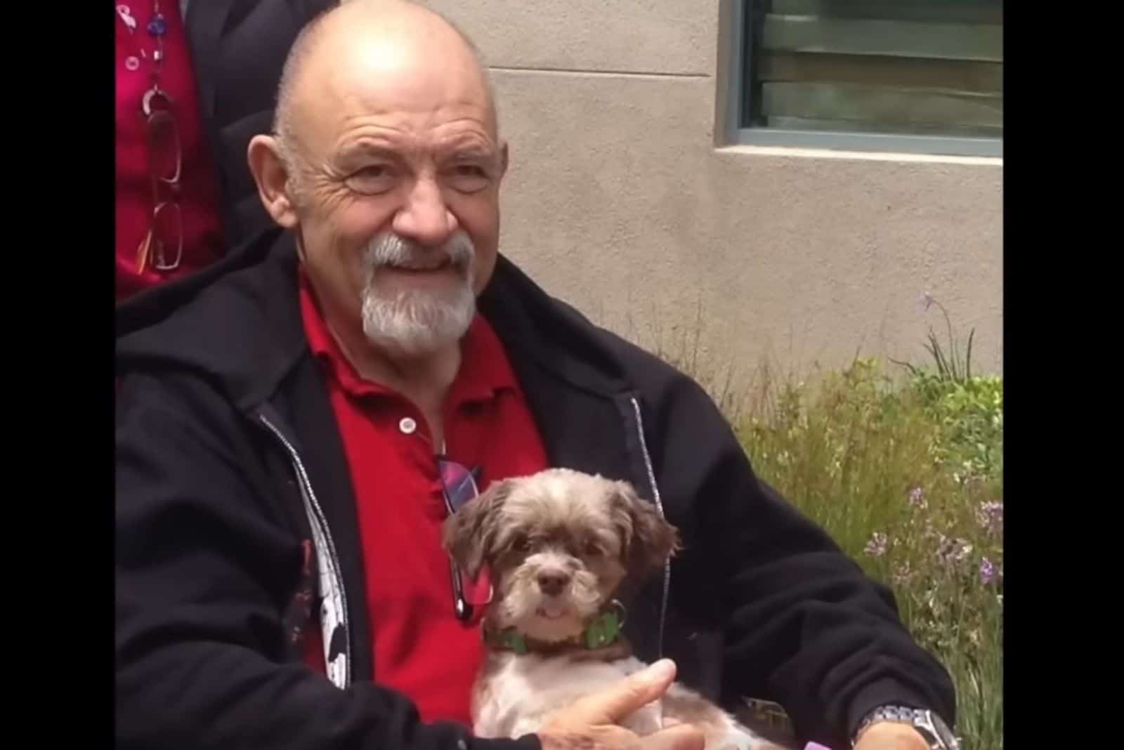 A man holding a dog