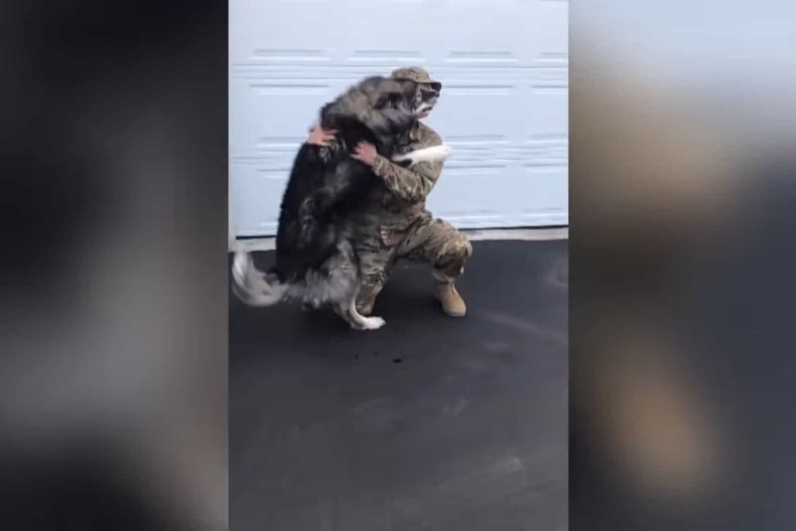 dog and soldier hugging each other