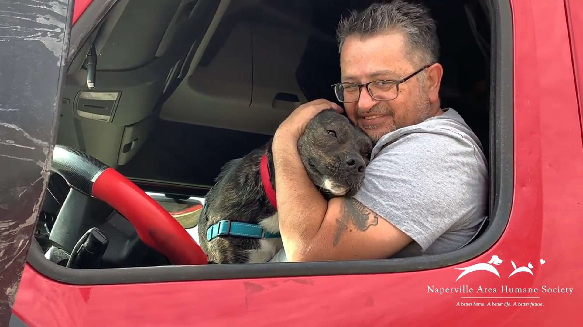 guy hugging the dog in truck