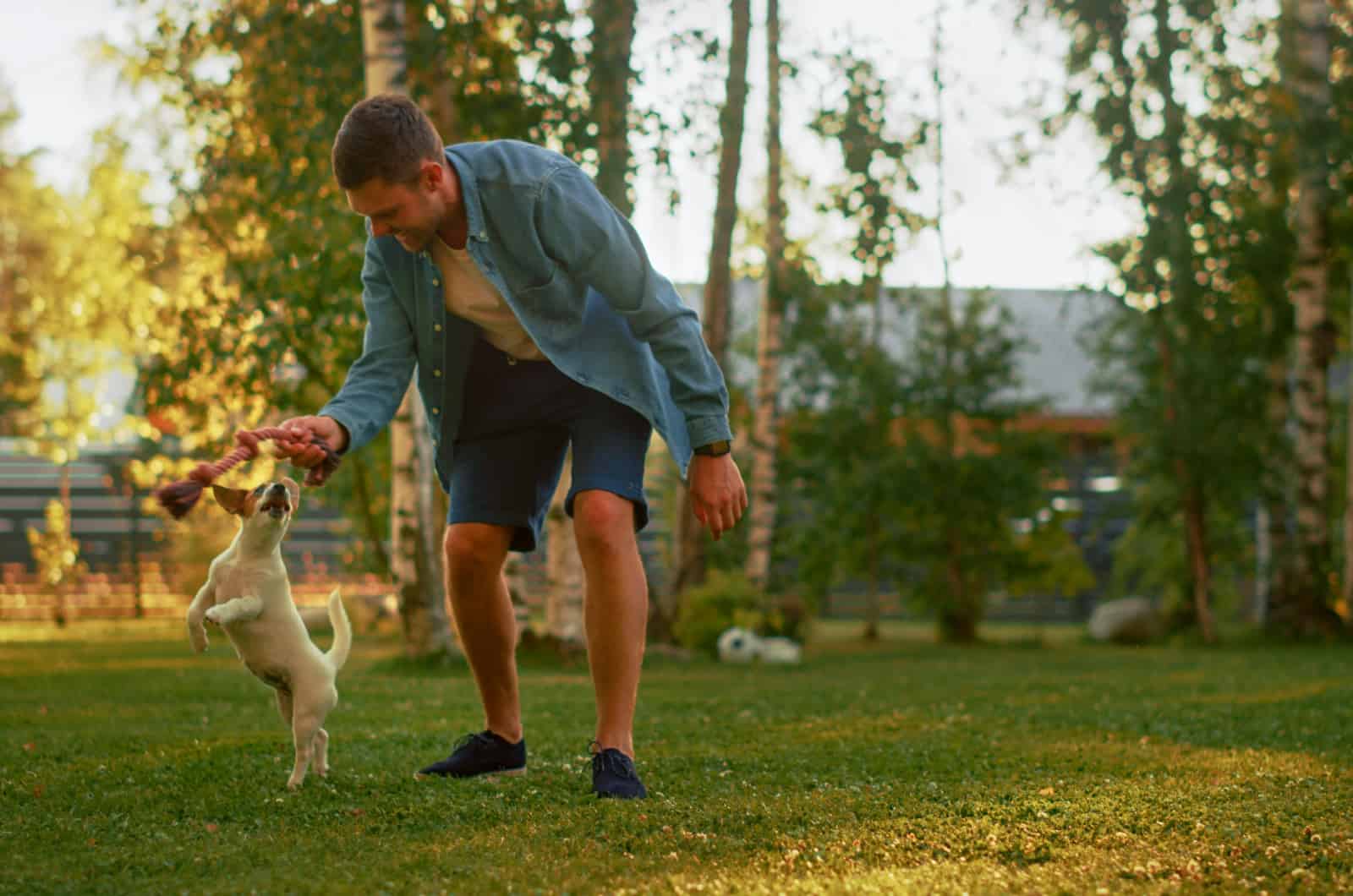 man plays fetch with a dog