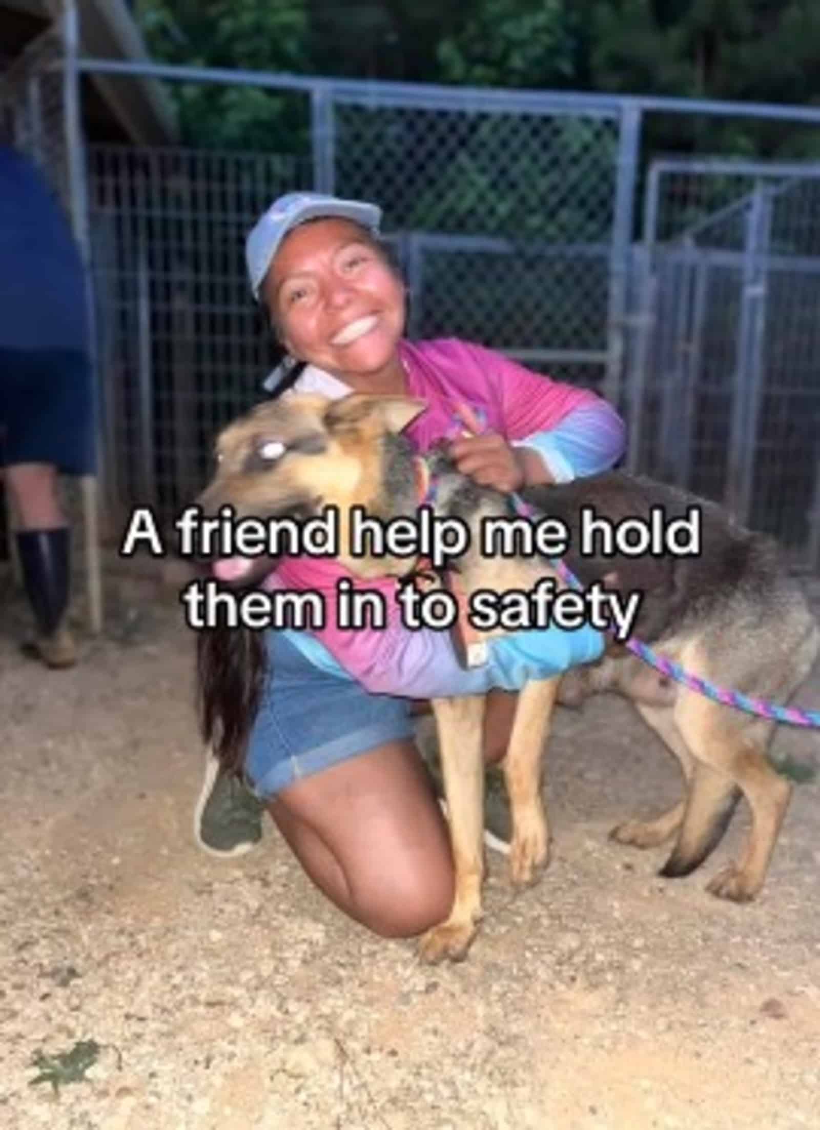 smiling woman embracing german shepherd dog while kneeling beside him