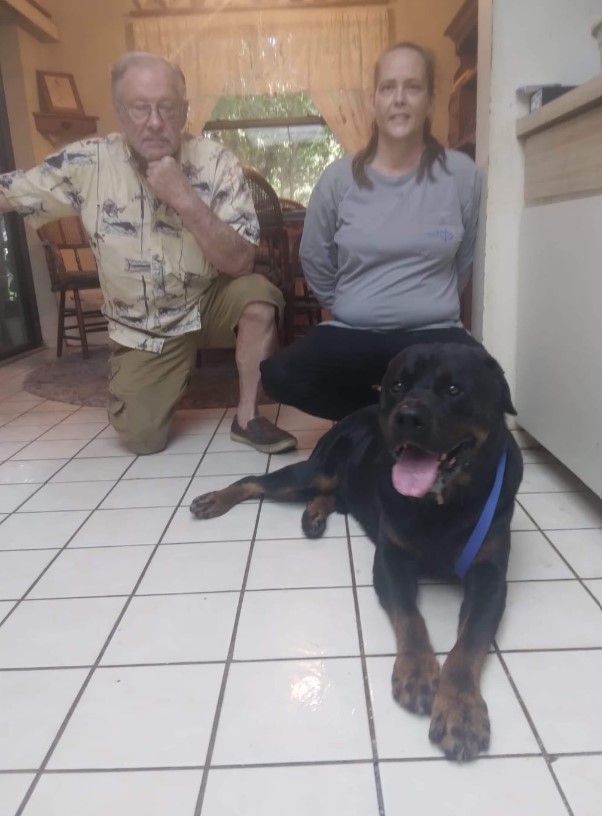 Rottweiler with his owners in the kitchen
